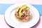 Mexican fish ceviche with avocado on colorful background