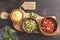 Mexican food concept. Various sauces to nachos or tacos in wooden bowls: guacamole, cheese sauce, pico del gallo. Top view, copy
