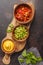Mexican food concept. Various sauces to nachos or tacos in wooden bowls: guacamole, cheese sauce, pico del gallo. Top view, copy