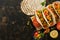 MEXICAN FOOD. Homemade tacos with shrimps and vegetables on a cutting board. View from above,overhead. Place for text