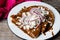 Mexican food: Mole sauce enchiladas with cream and fresh cheese