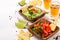 Mexican food sauce guacamole, salsa, chips and tequila shots with lime. Selective focus