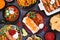 Mexican food table scene. Above view on a dark stone background.