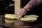 Mexican fresh corn tortillas being cooked on a traditional `comal`