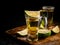 Mexican Gold Tequila with lime and salt on wooden table