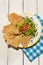 Mexican guacamole with pork chicharron on white background