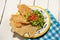 Mexican guacamole with pork chicharron on white background