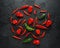 Mexican hot chili peppers colorful mix scotch bonnets habanero poblano serrano jalapeno on black background