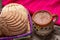 Mexican hot chocolate with sweet conchas bread on wooden background