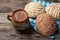 Mexican hot chocolate with sweet conchas bread on wooden background