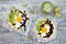 Mexican huevos rancheros tacos. Breakfast tostadas with black beans, avocado, fried egg, microgreens, sriracha ketchup. Top view