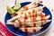 Mexican jicama  cutted with chili powder and piquant sauce on white background