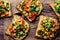 Mexican Latin American style open sandwiches. Vegetarian toasts with maize, avocado, tomatoes on wooden board. Rustic