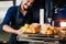 Mexican man baking bread called pan de muerto traditional from Mexico in Halloween