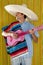 Mexican man serape poncho sombrero playing guitar
