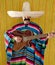 Mexican man serape poncho sombrero playing guitar