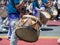 Mexican marching band beats on drums while walking down streets