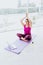 Mexican mature woman with headphones doing yoga with closed eyes listening to a guided meditation on laptop in Latin America