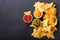 Mexican nachos corn chips with guacamole, salsa and cheese dip