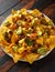 Mexican nachos tortilla chips with olives, jalapeno, guacamole, tomatoes salsa and cheese dip.