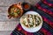 Mexican nopal cactus salad and tacos with cheese on wooden background