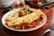 mexican omelette roll with salad served in a dish isolated on wooden background side view