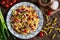 Mexican pasta salad with red bean, corn, tomato, onion and pepper
