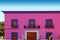 Mexican pink house facade wooden doors