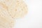 Mexican plain wheat tortilla wraps on white background, copy space