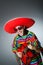 The mexican playing guitar wearing sombrero