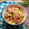 Mexican sausage ceviche with avocado on wooden background