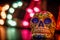 A mexican skull lit by multi colour lights