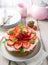 Mexican soaked cake topped with strawberries and cream