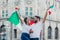 Mexican soccer fans holding flags and trumpets to celebrate in Mexico City