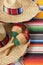 Mexican sombreros with maracas and traditional serape blankets.