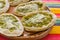 Mexican sopes with grated cheese and green salsa, mexican food spicy in mexico
