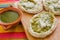 Mexican sopes with grated cheese and green salsa, mexican food spicy in mexico