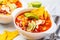 Mexican soup Chili con carne with beans, chicken, corn and nachos in white bowls - traditional mexican food