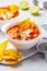 Mexican soup Chili con carne with beans, chicken, corn and nachos in white bowls - traditional mexican food