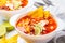 Mexican soup Chili con carne with beans, chicken, corn and nachos in white bowls - traditional mexican food