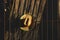 Mexican straw hat on sunlit dark brown wooden fence