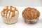 Mexican sweet bread Manteconchas vanilla and chocolate flavor cupcake type made with butter that is sold in bakeries in Mexico ori