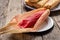 Mexican sweet tamales with strawberry jam on wooden background