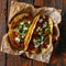 Mexican tacos with minced meat, onion and cilantro on wooden background