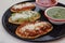 Mexican tlacoyos with green and red sauce, Traditional food in Mexico