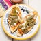 Mexican tlacoyos with nopal cactus and cheese on white background