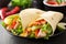 Mexican tortilla wrap with chicken breast and vegetables