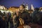 Mexican tourist enjoying hot chicken meat skewer from Christmas kiosk during Christmas event of lighting a Christmas tree at the O