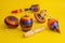 Mexican toys from Wooden, balero, yoyo and trompo in Mexico on a yellow background