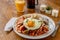 Mexican traditional chilaquiles breakfast Green red salsa Orange juice wooden